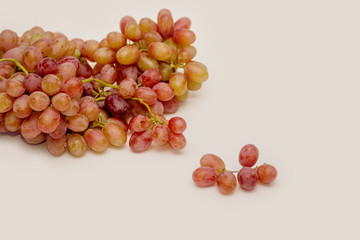 Red ripe grapes on neutral background