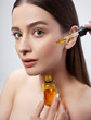 © Yakobchuk Olena - Beautiful young woman with perfect skin applying vitamin serum on her face