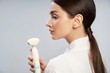 © Yakobchuk Olena - Charming young woman holding pore cleansing brush