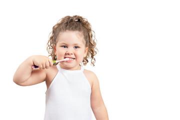 Cute blond girl brushing her teeth on isolated white background.