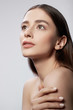 © Yakobchuk Olena - Beautiful young lady touching skin on her shoulder and looking away