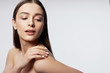 © Yakobchuk Olena - Beautiful young lady with perfect skin keeping hand on her shoulder