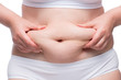 © kosmos111 - women's hands crumple fat on a fat belly, close-up shot in underwear