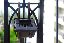 Black Cigarette Ashtray Hanging On Balcony On High Building