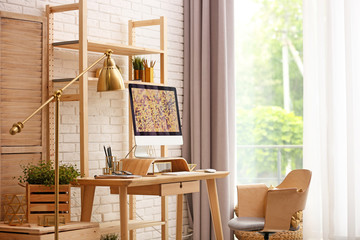 Canvas Print - Stylish room interior with modern workplace at brick wall