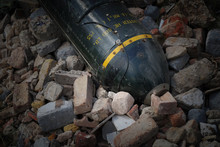 Unexploded Bomb In Rubble, Large Green Metal Missile