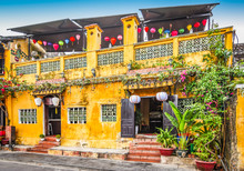 Bright Yellow Building With Lanterns In Ancient Town Of Hoi An, Vietnam, Asia.