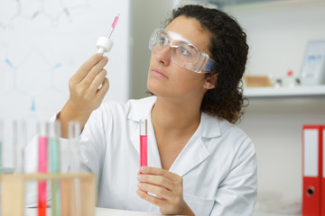 woman working with pipettes in a lab