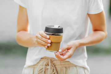 Wall Mural - Female hands hold reusable coffee mug.  Sustainable lifestyle. Eco friendly concept.