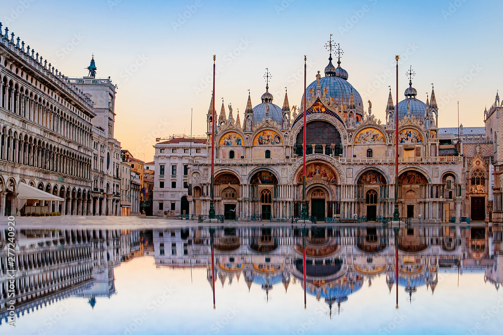 Sunrise in San Marco square with Campanile and San Marco's Basilica. The main square of the old town. Venice, Veneto Italy. Reflection on the flooded square. - obrazy, fototapety, plakaty 