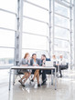 © alotofpeople - Business people laughing at workplace