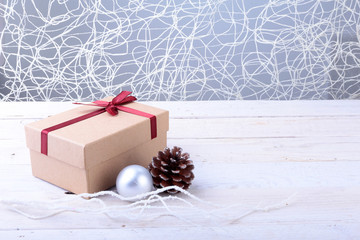 Wall Mural - Gift boxes with bow and christmas balls on wood background. Decoration