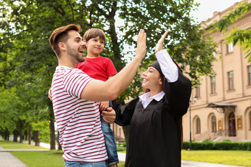 Wall Mural - Happy woman with her family on graduation day