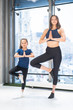 © teksomolika - Young adult mother and little daughter together practicing yoga