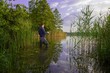 © mtmmarek - angler catching the fish  in the lake during summer day