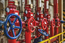 Blue And Red Valves On The Background Of Pipes In The Production Room