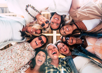 group of beautiful people in friendship enjoying the party outside on the terrace. large smiles for 