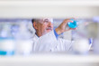 © lightpoet - Senior male researcher carrying out scientific research in a lab (shallow DOF; color toned image)