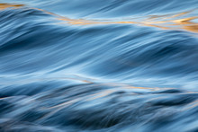 Water Concept - River Water Flowing With Light Reflecting Of Its Surface - Long Exposure Shot
