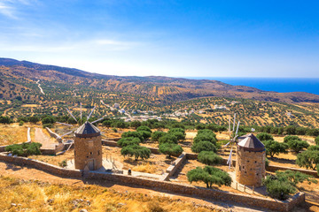 Typical landscape of Mirambellowith old windmills, olive treesand golden starch, Crete, Greece