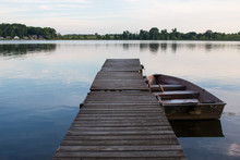 Rowboat On Lake Attached To A Dock