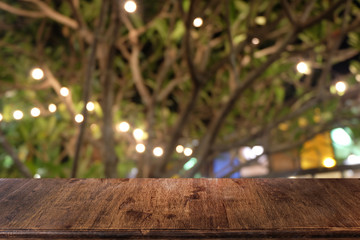 Empty dark wooden table in front of abstract blurred bokeh background of restaurant . can be used for display or montage your products.Mock up for space.