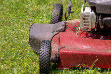 Old Grunge Red Lawnmower Cutting Grass