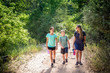 © Brocreative - A family hiking together along a scenic mountain trail on a summer day. Lifestyle photo of people outdoors enjoying nature and being active