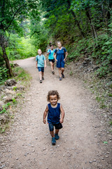Wall Mural - family hiking together along a scenic mountain trail on a summer day. selective focus lifestyle phot