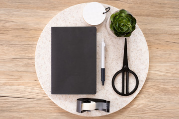 Poster - top view black notebook with office stationery on wooden table with copy space.student stuff on desk.education concept.