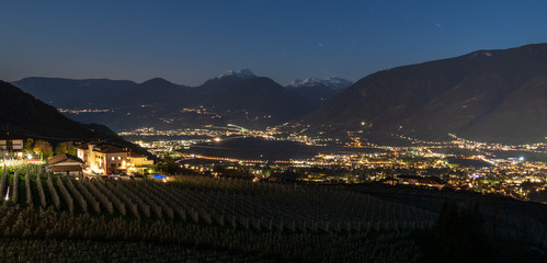 Night Skyline panorama of Meran valley and vineyards of Scena in Burggrafenamt, Meraner Land. Province Bolzano, South Tyrol, Italy. Europe.