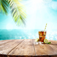 Summer drink on desk and beach landscape 