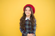 © be free - small girl kid with long curly hair. fashionable school uniform. kid fashion. parisian fashion girl. childrens day. child on yellow background. happy girl in french beret. Joyful mood