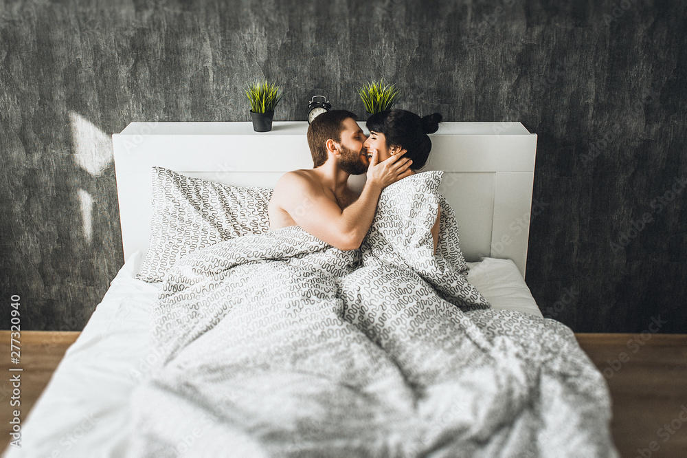 Photo Stock Man and woman in bed. Man and woman have sex. Couple in