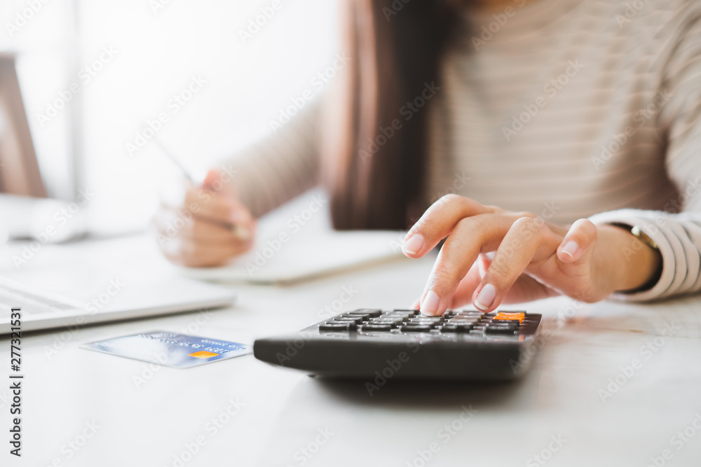 Woman accountant working with computer and calculator for business and financial expense - obrazy, fototapety, plakaty 