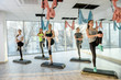 © RomanR - Group of ladies making exercises in gym