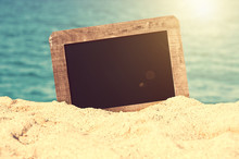 Vintage Blank Chalkboard In The Sand Of A Beach, Summer Background