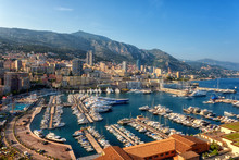 Panoramic View Of Monaco Harbor, Monte Carlo. Scenic Summer Cityscape With Buildings, Mountains, Luxury Yachts And Blue Sky, Cote D'Azur, Microstate Of The French Riviera, Outdoor Travel Background