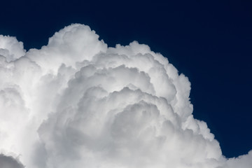 white cumulus fluffy clouds against a deep blue sky background. dramatic sky backdrop for design and