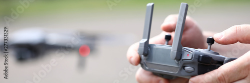 Fotografía Modern video recording drone controlled with male hands holding remote controlle