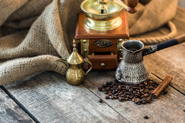 Turkish coffee concept. Copper coffee pot, vintage coffee grinder, coffee beans