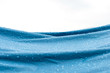 Water drops on the blue nylon fabric tent after rain with white background and copy space.
