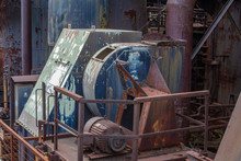 Machinery On Exterior Of An Old Steel Manufacturing Plant, Heavy Rust And Paint Patina, Horizontal Aspect