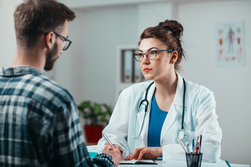 Woman Doctor prescribes medicine to Young Patient