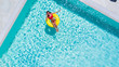 © F8  \ Suport Ukraine - Aerial view of young sexy woman in bikini swimming on the inflatable big yellow ring in pool