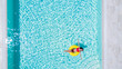 © F8  \ Suport Ukraine - Aerial view of young sexy woman in bikini swimming on the inflatable big yellow ring in pool