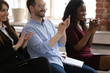 © fizkes - Diverse happy business team audience group applauding sit on chairs