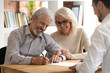 © fizkes - Happy older couple clients sign insurance contract meeting agent