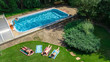 © Iuliia Sokolovska - Happy family relaxing by swimming pool, aerial drone view from above of parents and kids have fun on vacation, family weekend on resort