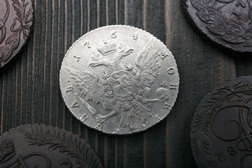 Numismatics. Old collectible coins made of silver and copper on a old wooden table.